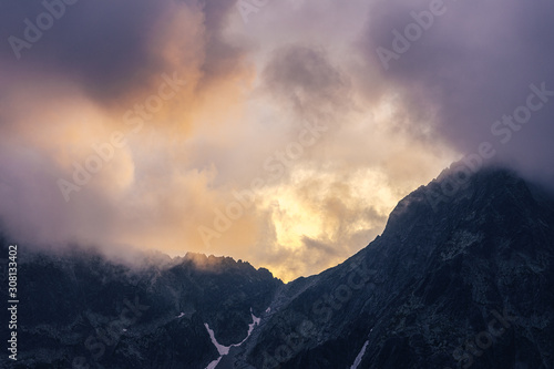 Dramatic sunset over a moutain alpine like landscape of High Tatras, Slovakia. Rugged rocky mountains during spectacular sunset or sunrise. High peaks of Tatra mountains.