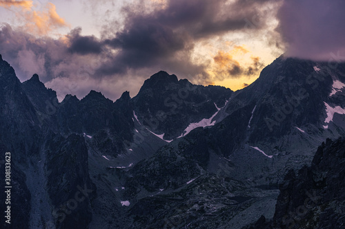 Dramatic sunset over a moutain alpine like landscape of High Tatras, Slovakia. Rugged rocky mountains during spectacular sunset or sunrise. High peaks of Tatra mountains.
