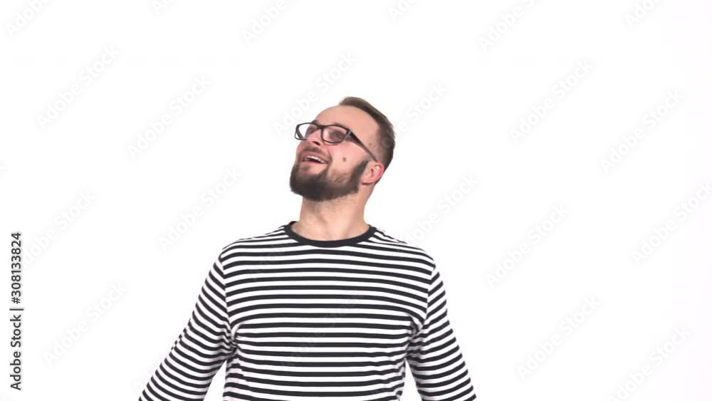 Young cheerful man making funny grimace at camera and making ridiculous chaotic movements. Bearded man with funny emotional face expression looking up. Isolated, on white background Young cheerful man making funny grimace at camera and making ridiculous chaotic movements. Bearded man with funny emotional face expression looking up. Isolated, on white background