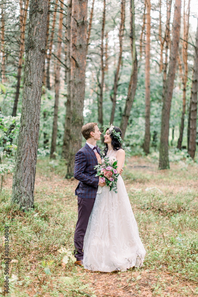 beautiful bride with a handsome groom at the forest beautiful bride with a handsome groom at the forest
