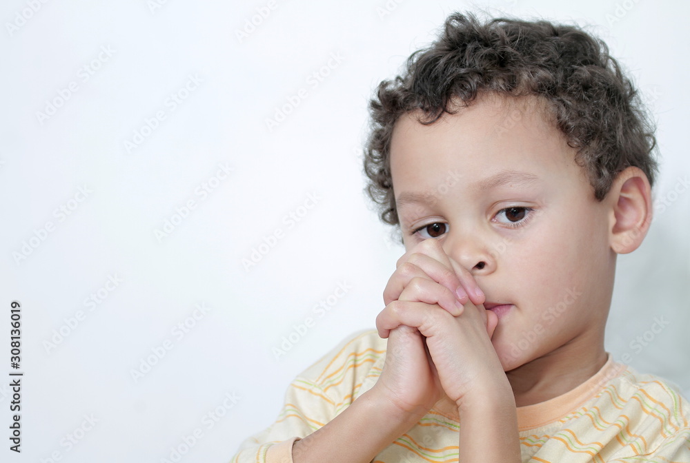 boy praying to God with hands held together on white background stock photo boy praying to God with hands held together on white background stock photo
