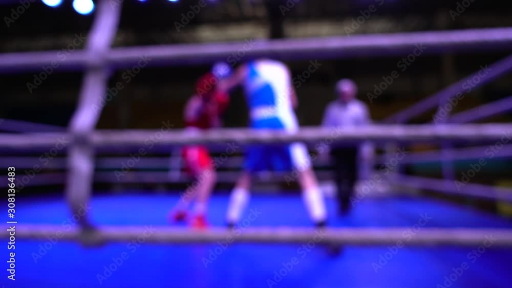 Boxers box in the ring. Out of focus. Slow motion. Boxers box in the ring. Out of focus. Slow motion.