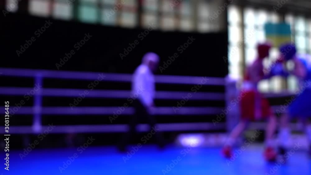 Boxers box in the ring. Out of focus. Slow motion. Boxers box in the ring. Out of focus. Slow motion.