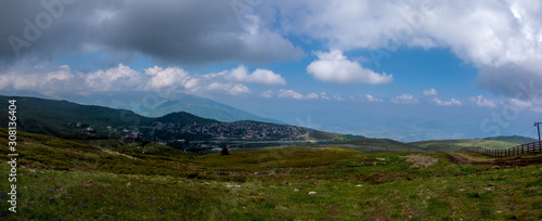 Panorama view of colorful mountains  meadow  and valley with clouds in the background.Ski resort. Early morning  Sharr Mountains  Popova Shapka  North Macedonia.