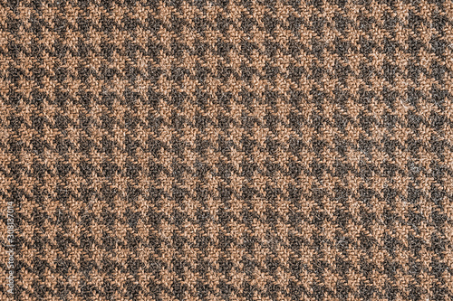 Seamless brown and black generic houndstooth fabric pattern background texture.