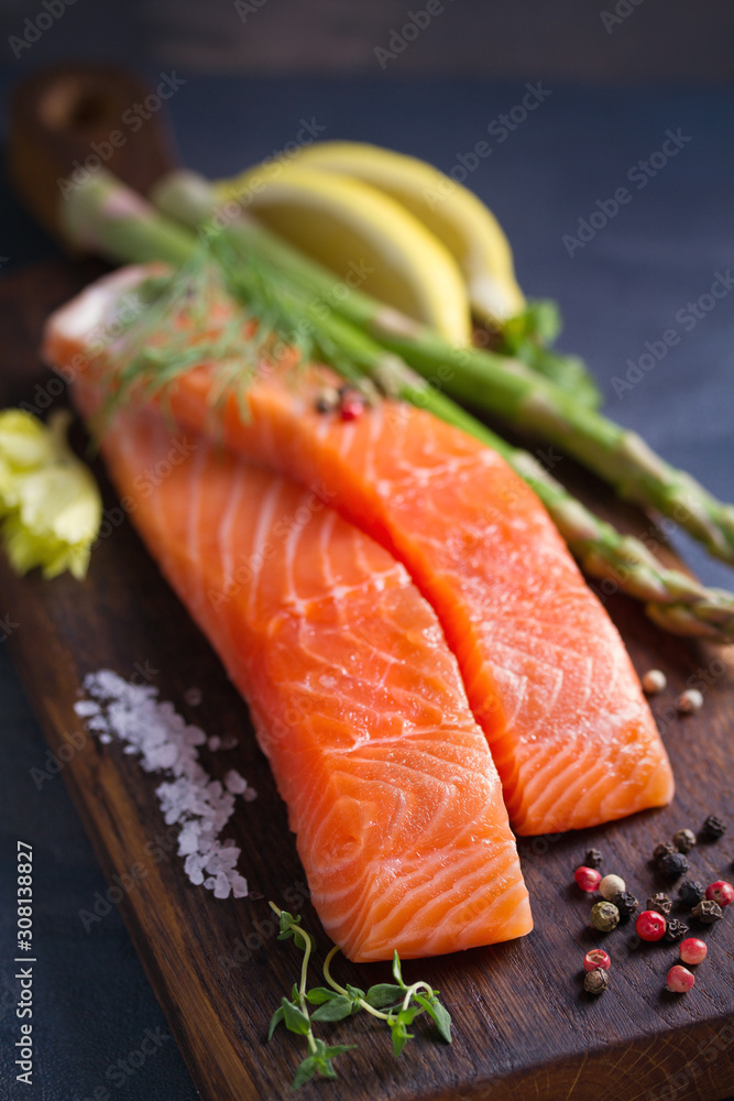 Fresh raw salmon fillet steak with vegetables and ingredients prepared for cooking Fresh raw salmon fillet steak with vegetables and ingredients prepared for cooking