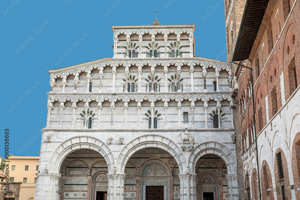 Romanesque Facade and bell tower of St. Martin  Cathedral in Lucca, Tuscany. It contains most precious relic in Lucca, Holy Face of Lucca