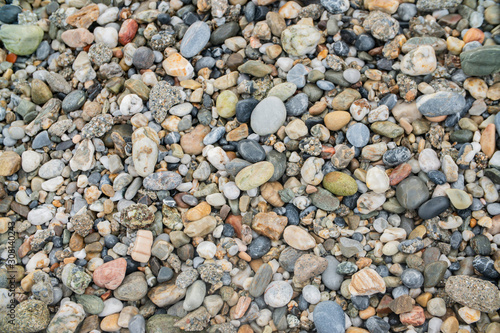 background surface of sea pebbles, stones and sand