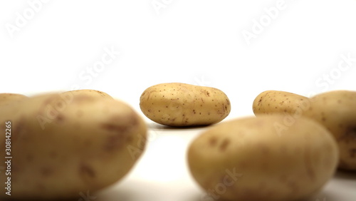 Young white potato, top view. Isolated potatoes on a white background. Fresh food for vegetarians. Raw vegetable, root vegetable. Photo harvesting potatoes for a designer.