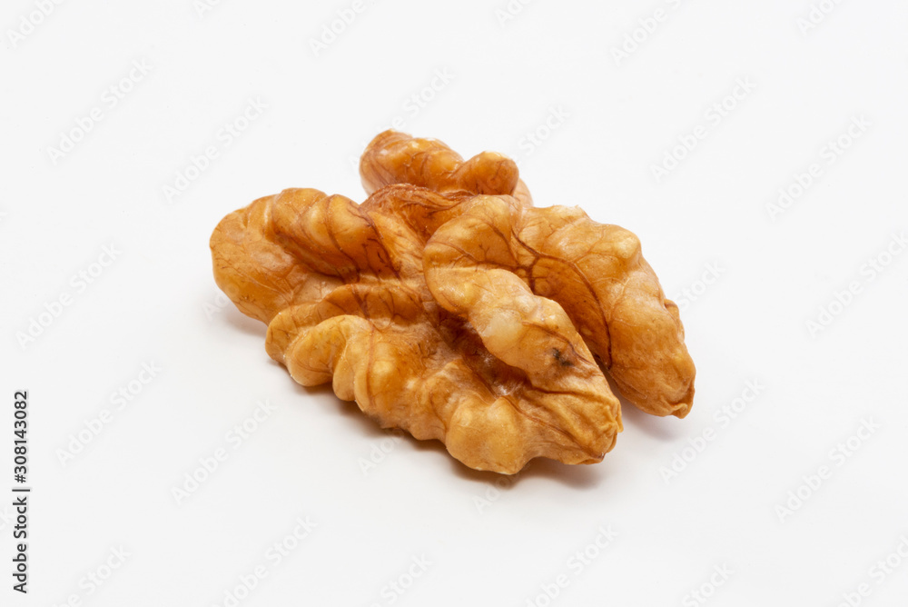 One peeled walnut on a white background. One peeled walnut on a white background.