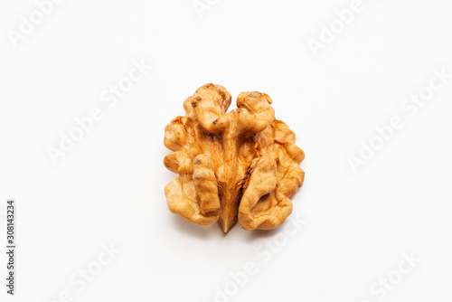 One peeled walnut on a white background.