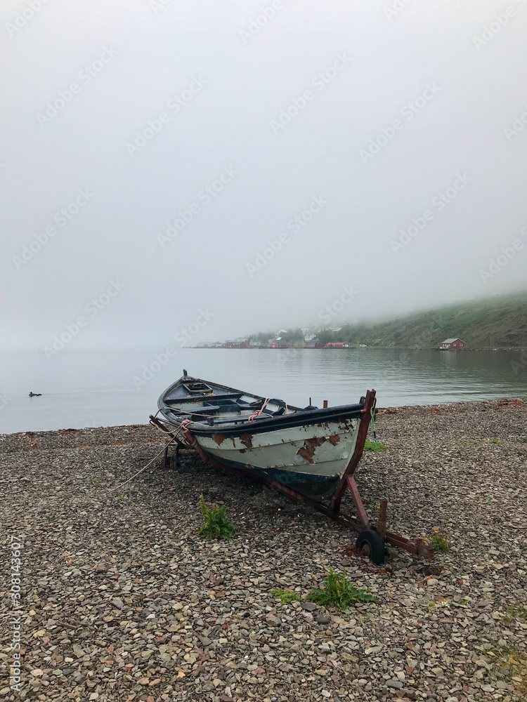 Lonely rowboat sitting on shore