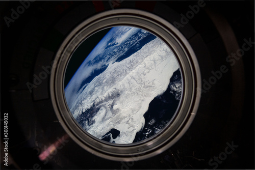 view of earth from satellite window in space