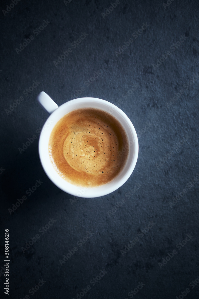 Cup of coffee on dark stone background. Top view. Copy space Cup of coffee on dark stone background. Top view. Copy space