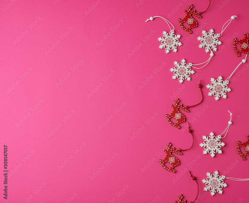 wooden carved Christmas decorations for the holiday tree on a pink background wooden carved Christmas decorations for the holiday tree on a pink background