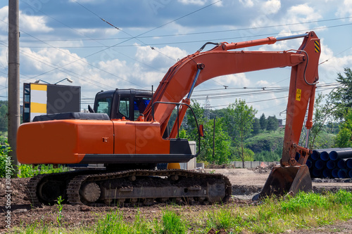 Excavator at a construction site. Excavator loader machine during earthmoving works outdoors at construction site.