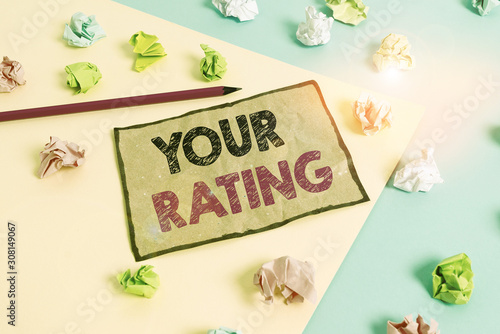 Handwriting text writing Your Rating. Conceptual photo score or measurement of how good or popular a demonstrating is Colored crumpled papers empty reminder blue yellow background clothespin