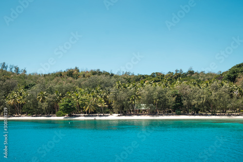 Small inhabited island in group of Yasawa, Fiji with crystal clear water, holiday destination © Klara