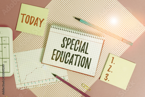 Text sign showing Special Education. Business photo showcasing form of learning given to students with mental challenges Writing equipments and computer stuffs placed above colored plain table