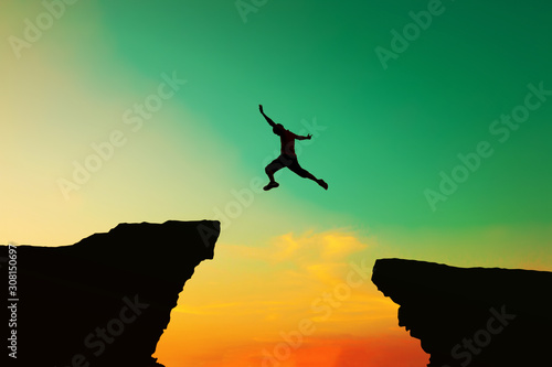 Quadro su tela A determined businessman jumps over obstacles symbolizing challenges in business and success