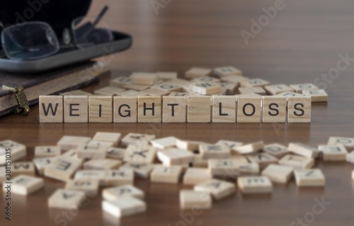 weight loss the word or concept represented by wooden letter tiles