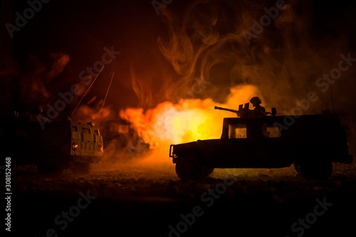 Military patrol car on sunset background. Army war concept. Silhouette of armored vehicle with soldiers ready to attack. Artwork decoration. Selective focus