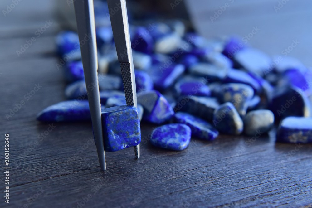 Lapis Is a beautiful natural gemstone on a wooden floor Lapis Is a beautiful natural gemstone on a wooden floor