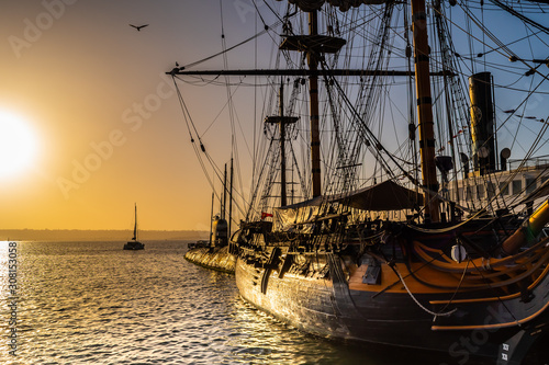 HMS Surprise ship, a tall modern replica of HMS Rose docked at Maritime Museum on the waterfront harbor bay in San Diego, Southern California at sunset.