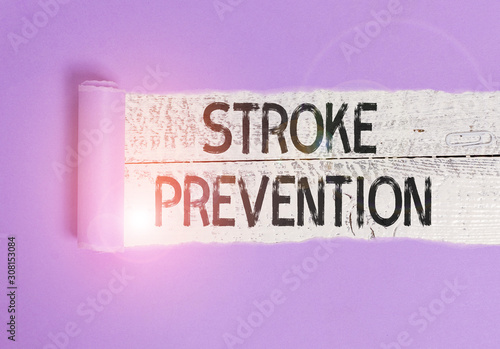 Writing note showing Stroke Prevention. Business concept for identified demonstratingal risk factors and change lifestyle Cardboard which is torn placed above a wooden classic table