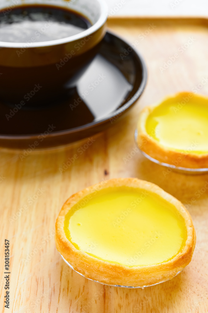 fresh egg tarts with cup of coffee on back fresh egg tarts with cup of coffee on back