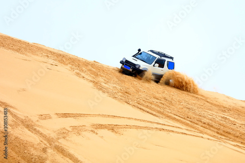 An suv was driving in the desert. © zhengzaishanchu