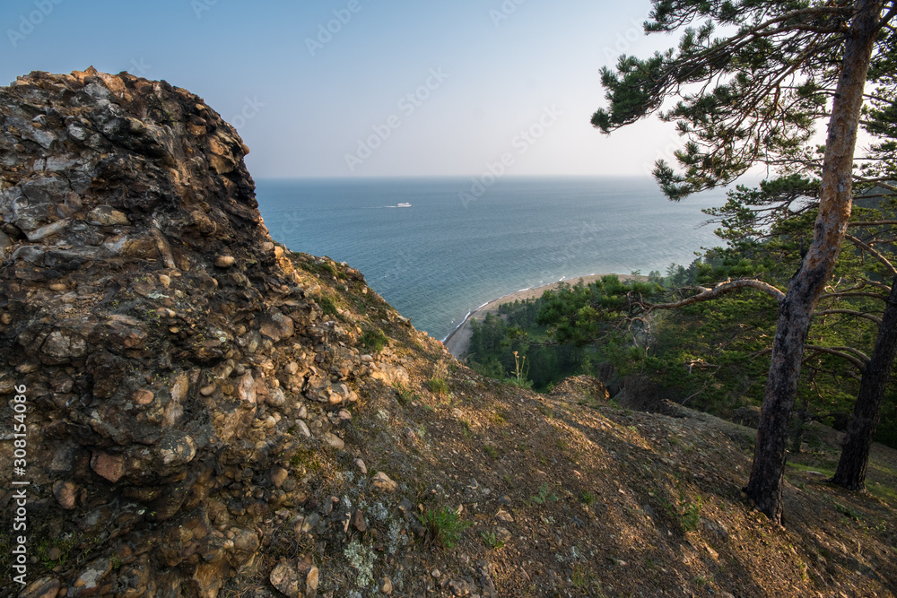 Pine forest on top of a rocky cliff on Lake Baikal