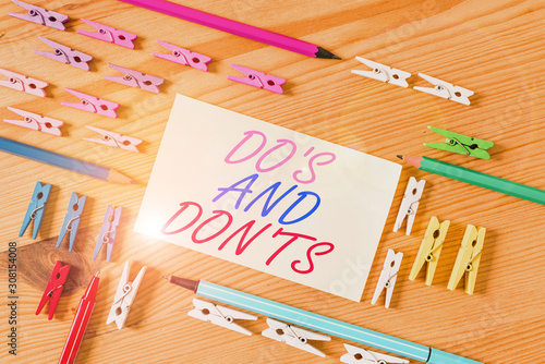 Handwriting text Do S And Don Ts. Conceptual photo Technologically complication of making a decision Colored clothespin papers empty reminder wooden floor background office