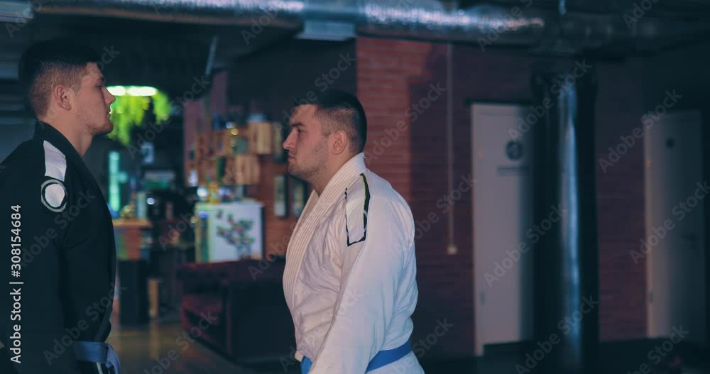 Serious Jtujitsu fighters go to meet each other, a serious look at the enemy before the battle. Circular motion of the camera. Serious Jtujitsu fighters go to meet each other, a serious look at the enemy before the battle. Circular motion of the camera.