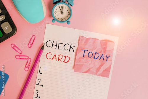 Text sign showing Check Card. Business photo showcasing allows an account holder to access funds in her account Calculator clips clock clipboard mouse sheet note pencil color background