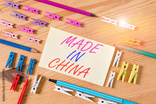 Handwriting text Made In China. Conceptual photo Wholesale Industry Marketplace Global Trade Asian Commerce Colored clothespin papers empty reminder wooden floor background office photo