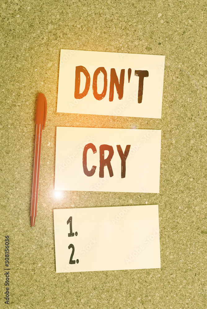 Conceptual hand writing showing Don T Cry. Concept meaning Shed tears  typically as an expression of distress pain or sorrow Reminder pile colored  crumpled paper clothespin wooden space Stock Photo