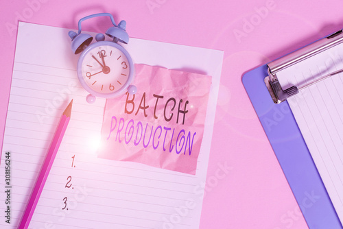 Handwriting text writing Batch Production. Conceptual photo products are analysisufactured in groups called batches Paper sheet note clipboard pencil vintage alarm clock colored background photo