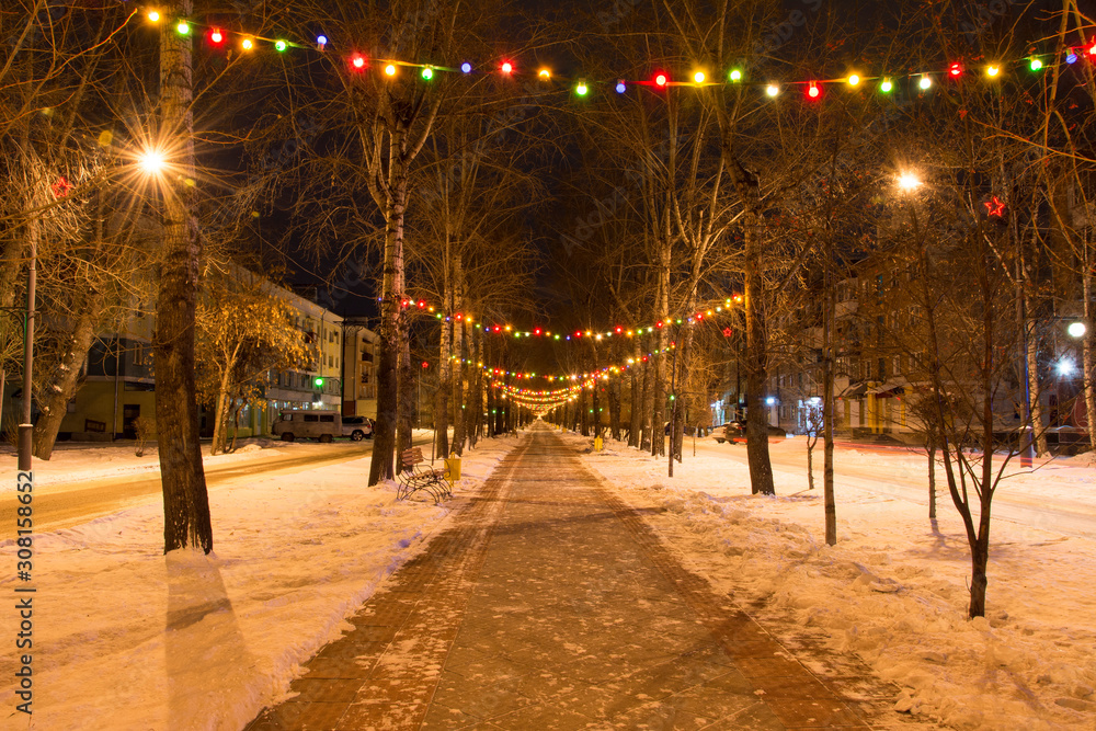 The streets of a provincial town are decorated before Christmas and New Year. Russia. Abakan.