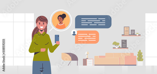 girl using smartphone social network chat bubble communication concept woman chatting with friend online mobile app modern living room interior portrait horizontal vector illustration