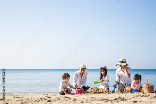 Family traveling concept. Happy family playing on the beach on summer holiday.