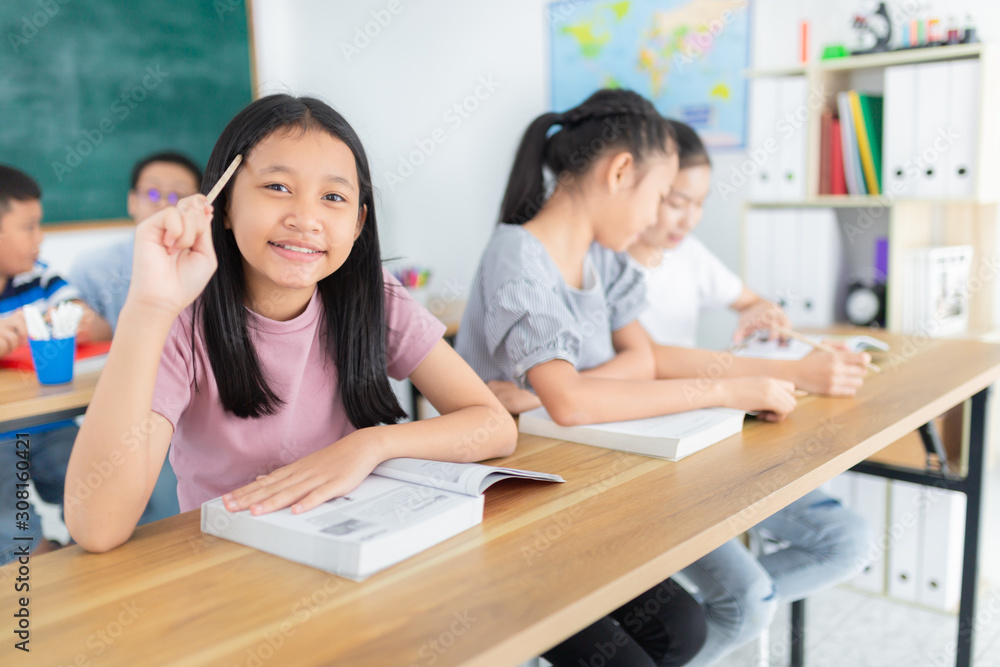asian girl use pencil and touch her head, asian student group do homework in classroom, they sharing knowledge together, they explaining about important lesson to friends, happiness elementary school asian girl use pencil and touch her head, asian student group do homework in classroom, they sharing knowledge together, they explaining about important lesson to friends, happiness elementary school