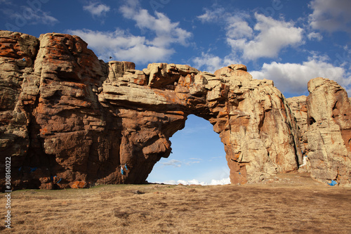 Rock arch in mongolia in cloudy day photo