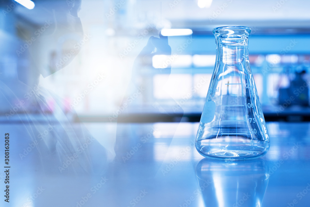 single science glass flask with scientist holding tube in chemistry blue laboratory background single science glass flask with scientist holding tube in chemistry blue laboratory background