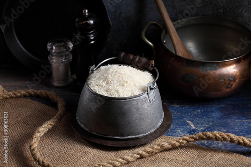 Close up white rice in measuring cup on table, Thai Jasmine rice in rustic kitchen background
