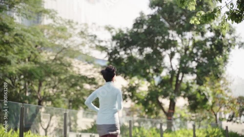 Asian beauty jogging in city park in morning slow motion