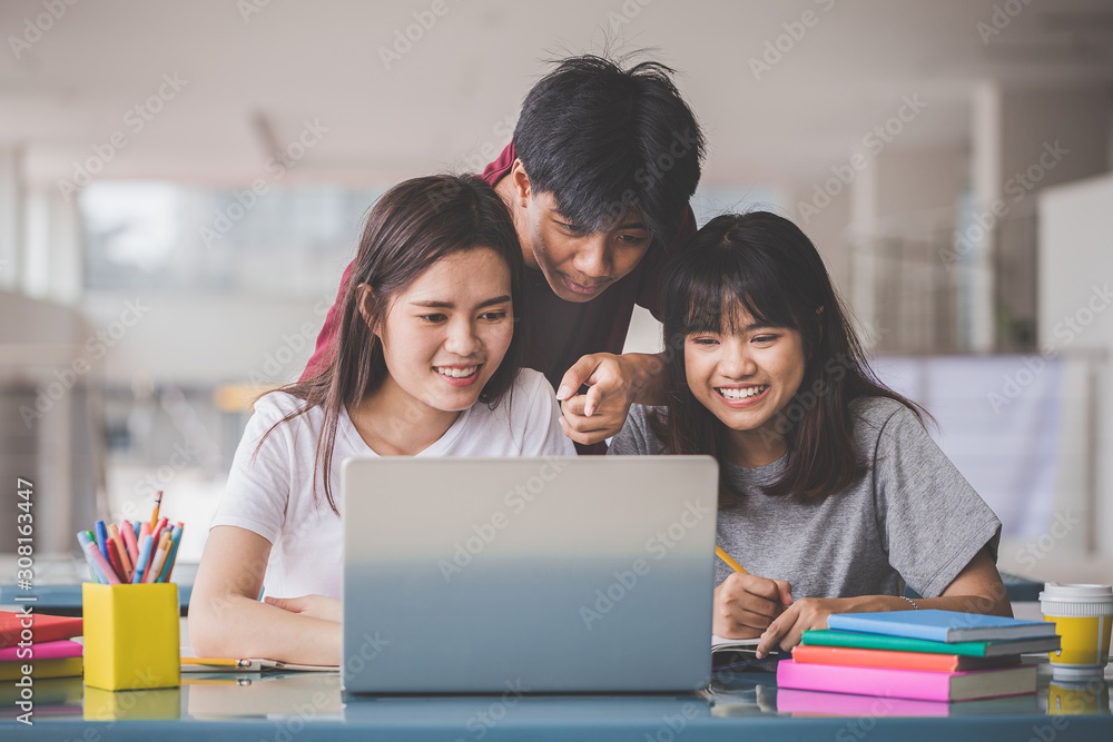 Education concept - Group of young people studying at the university sitting in the hall to read book for the final exam. Education concept - Group of young people studying at the university sitting in the hall to read book for the final exam.