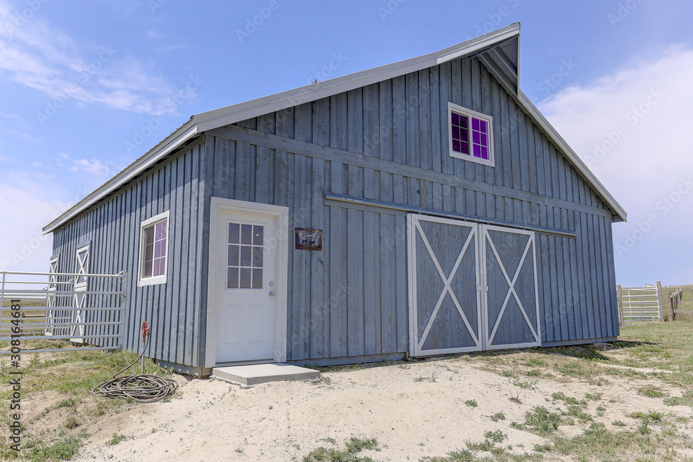 Classic grey barn with loft and white trim