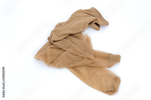Women's nylon tights comfortable pantyhose beige tan color lingerie tights on isolated white background.