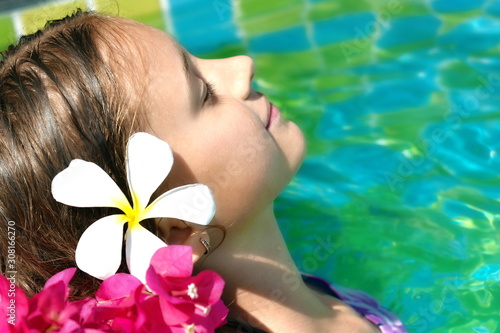 Girl enjoys in the pool. A relaxing holiday at sea. Beauty spa concept for body.